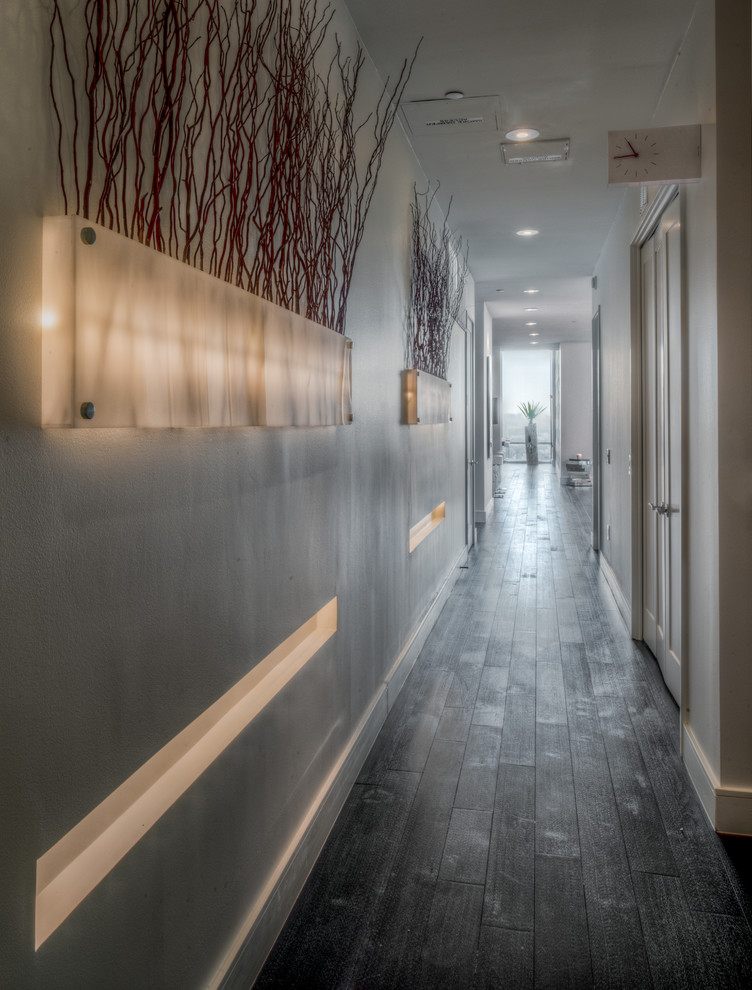 Hallway - large contemporary dark wood floor hallway idea in Houston with white walls