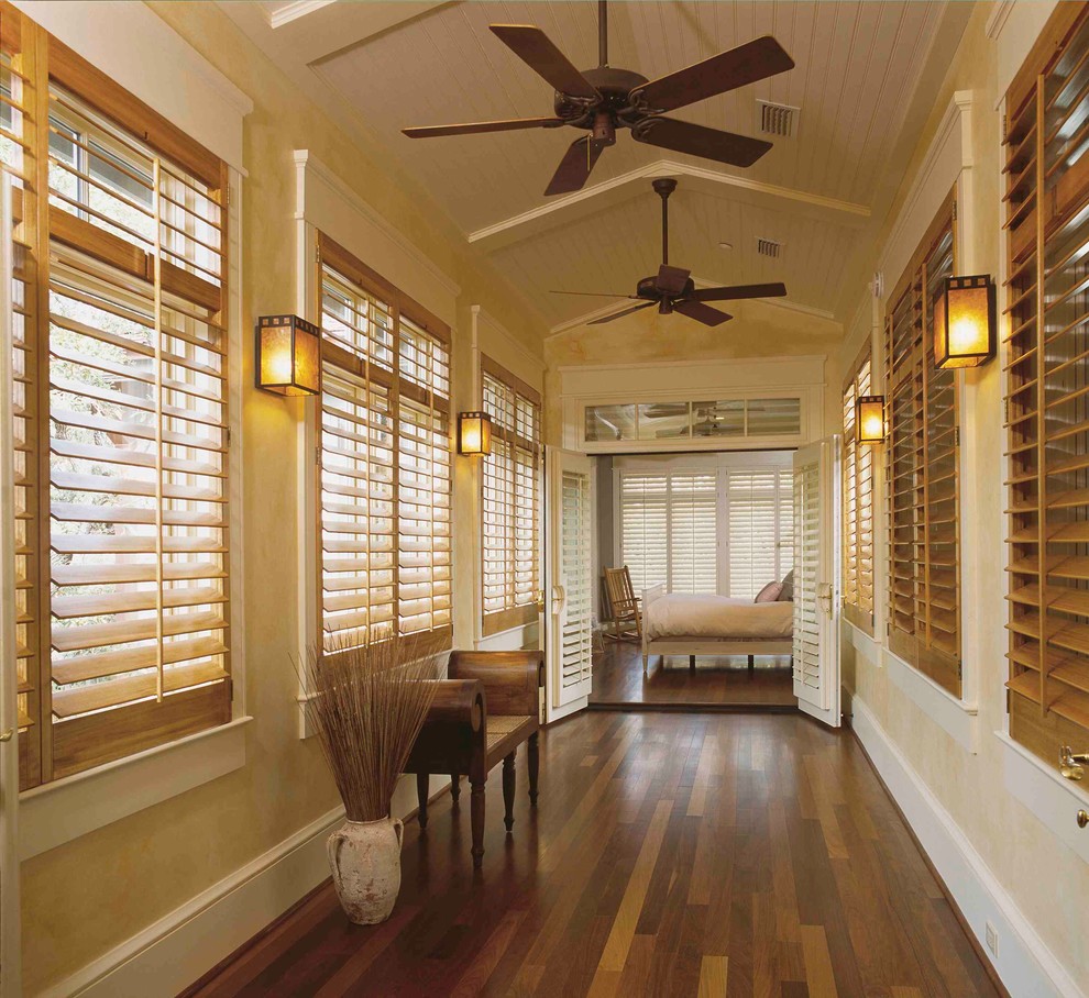 Mid-sized island style medium tone wood floor and brown floor hallway photo in Dallas with beige walls