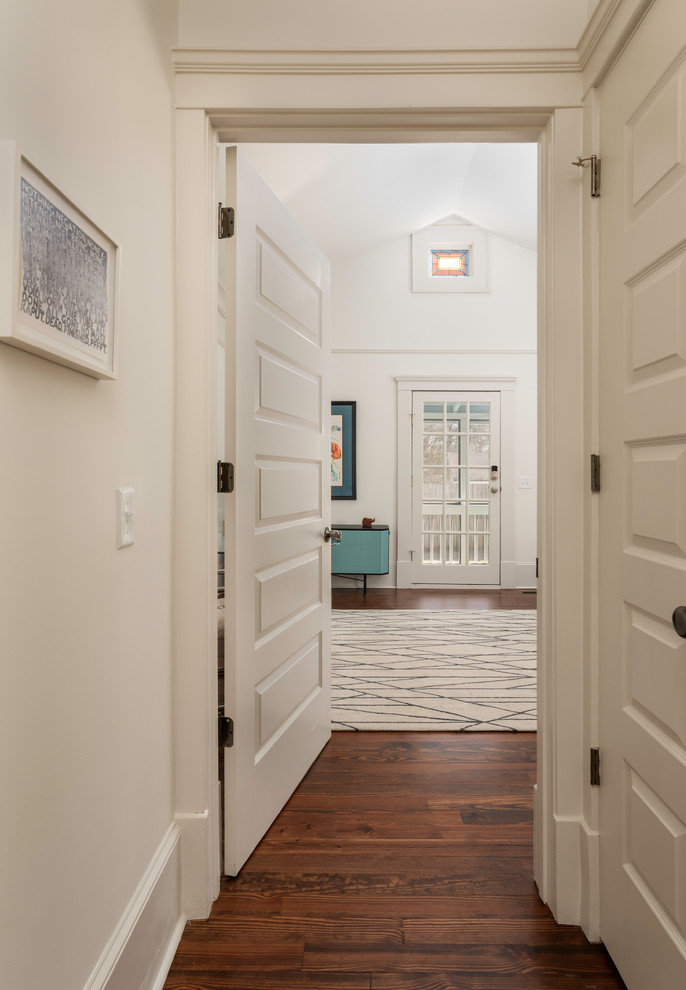 Mid-sized ornate medium tone wood floor and brown floor hallway photo in Atlanta with white walls