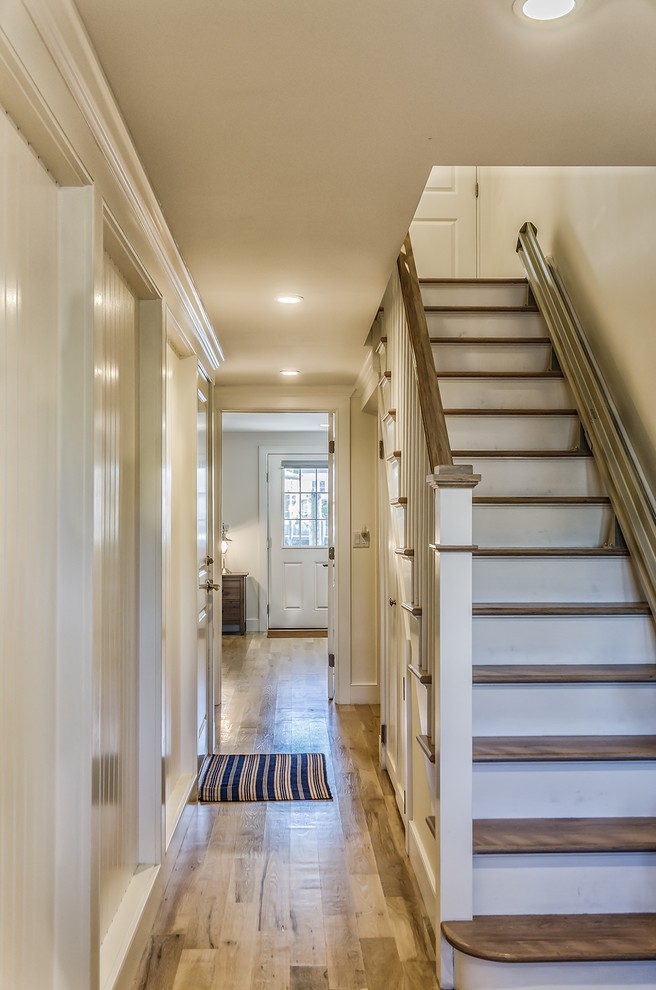 Inspiration for a mid-sized light wood floor hallway remodel in New York with beige walls