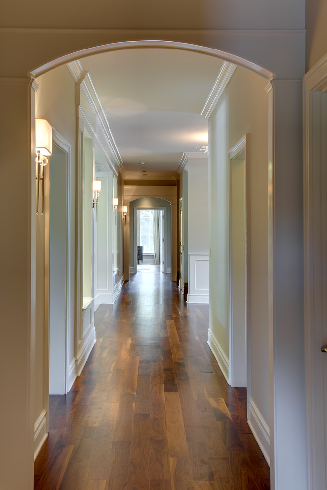 Example of a large classic dark wood floor hallway design in Bridgeport with beige walls