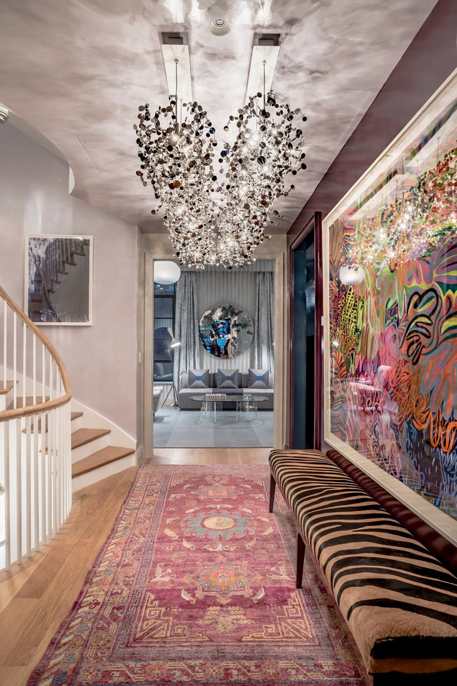 Inspiration for a large eclectic medium tone wood floor hallway remodel in New York with purple walls