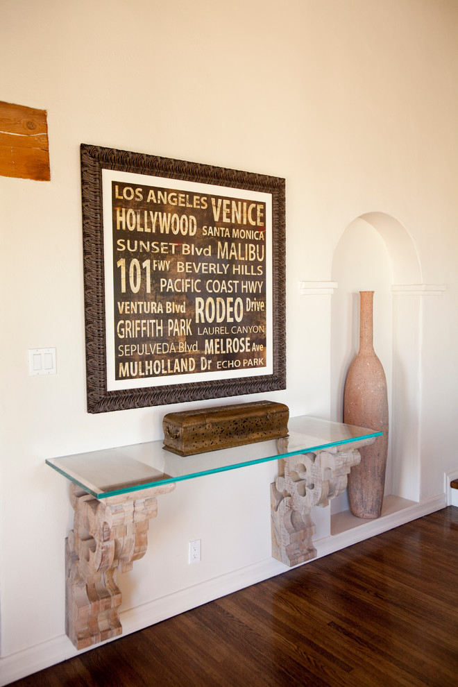 Example of a transitional dark wood floor hallway design in Los Angeles with white walls