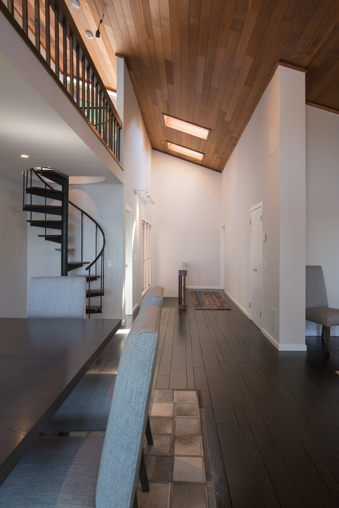 Hallway - mid-sized contemporary medium tone wood floor and black floor hallway idea in Orange County with white walls