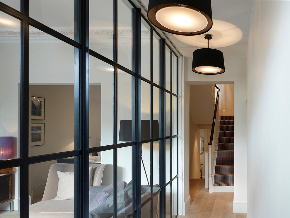 Example of a trendy hallway design in London with white walls
