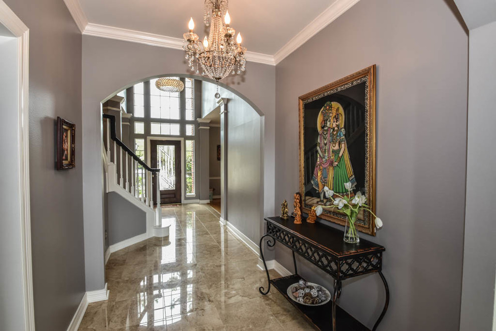 Example of a transitional travertine floor hallway design in Houston with gray walls