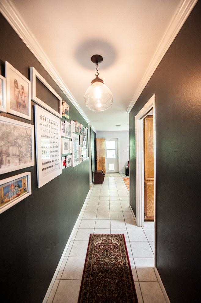 Hallway - mid-sized contemporary ceramic tile hallway idea in Houston with black walls