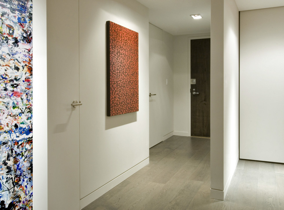 Foto di un ingresso o corridoio design con pavimento in legno massello medio