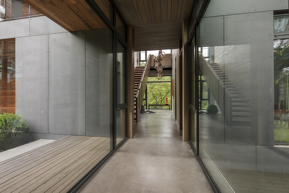 Imagen de recibidores y pasillos modernos grandes con suelo de cemento y suelo gris