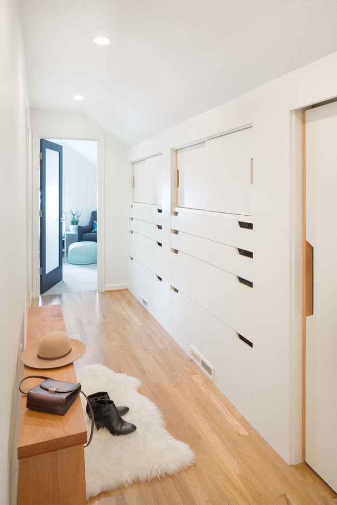 Inspiration for a small scandinavian light wood floor hallway remodel in Portland with white walls