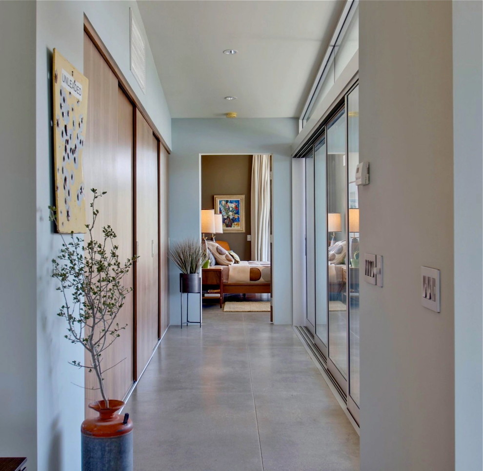 Hallway - mid-sized 1950s concrete floor hallway idea in Los Angeles with blue walls