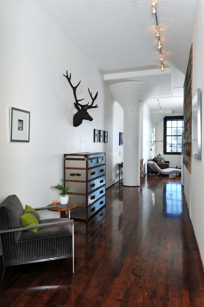 Hallway - industrial dark wood floor hallway idea in San Francisco with white walls