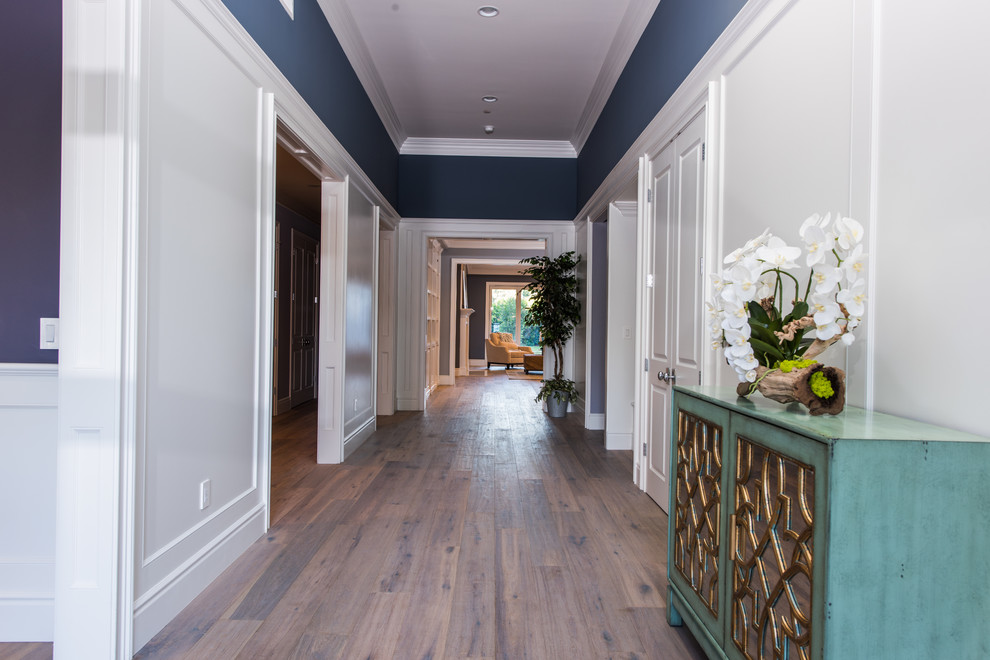 Hallway - large contemporary dark wood floor hallway idea in Los Angeles with blue walls