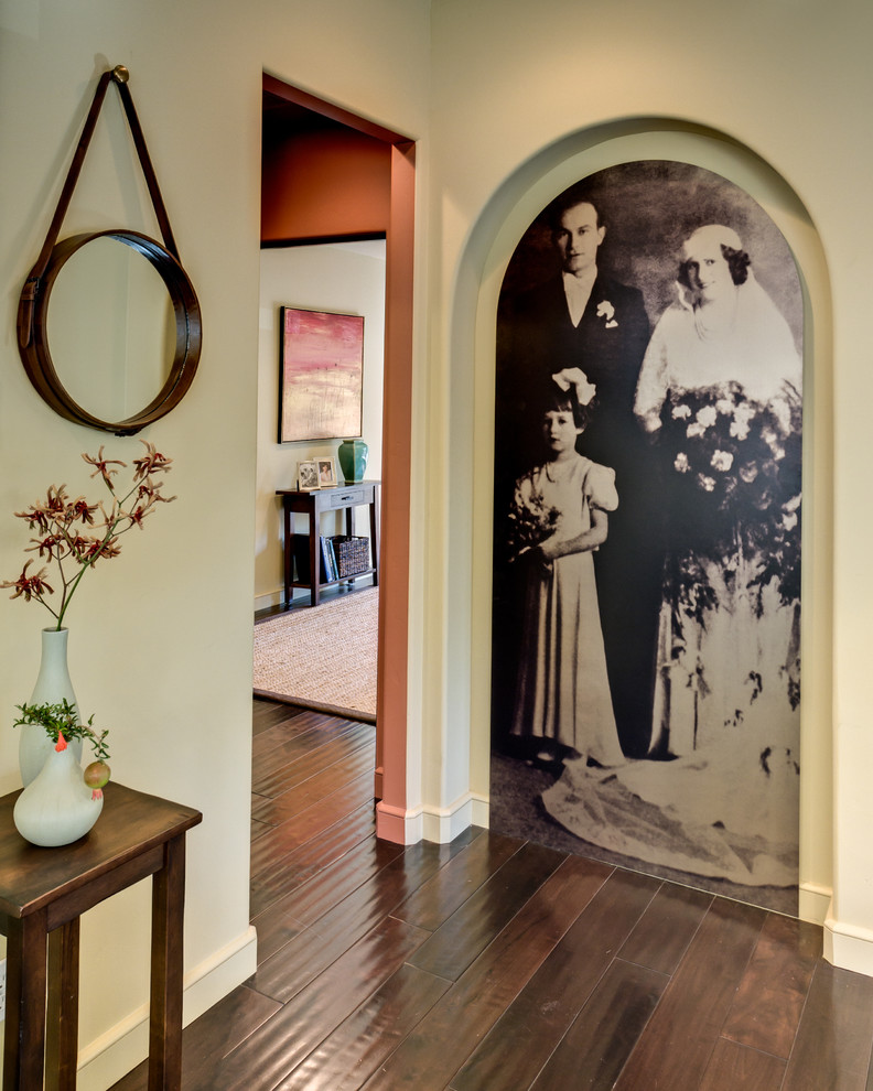 Example of a mid-sized tuscan dark wood floor and brown floor hallway design in San Francisco with beige walls