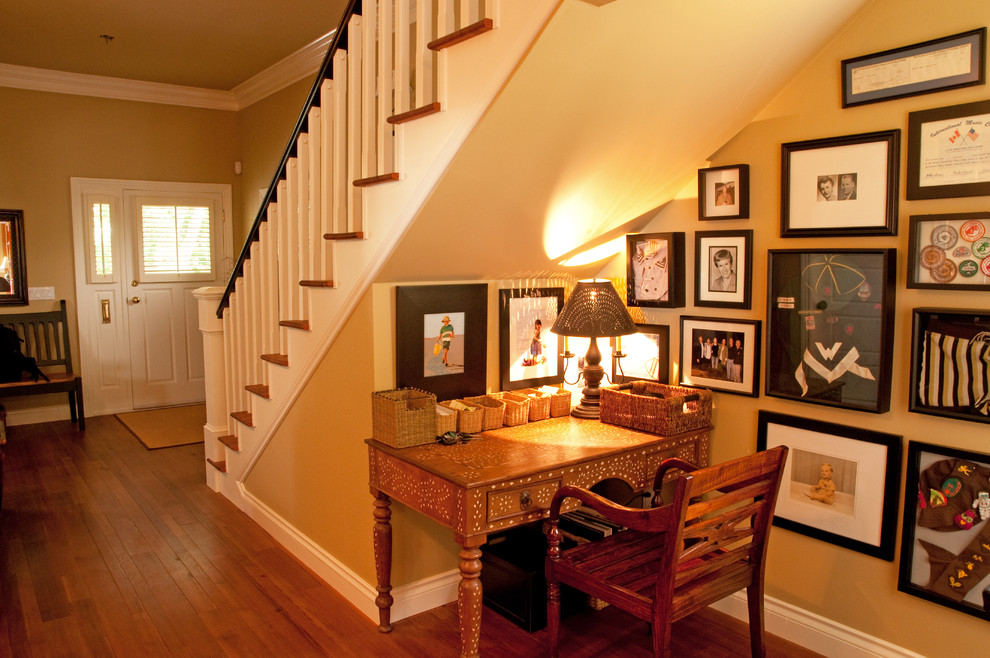 Inspiration for a mid-sized timeless medium tone wood floor and brown floor hallway remodel in Vancouver with beige walls