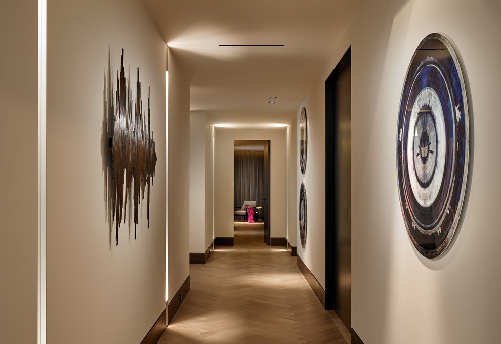 Large trendy medium tone wood floor and gray floor hallway photo in Miami with gray walls
