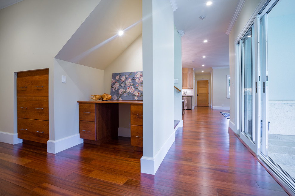 Large island style medium tone wood floor and brown floor hallway photo in Hawaii with beige walls