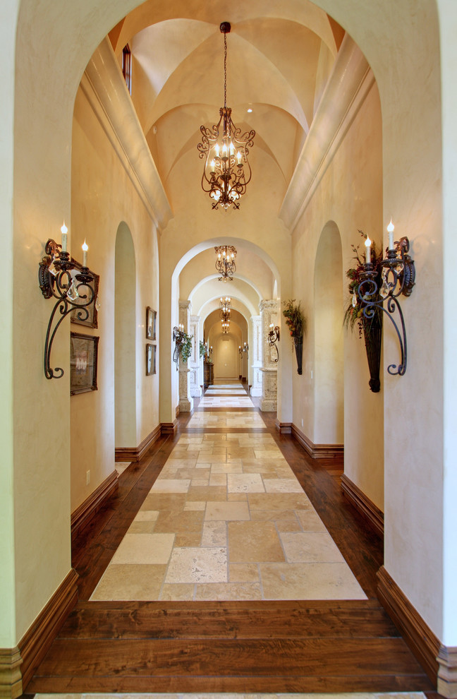 Imagen de recibidores y pasillos mediterráneos extra grandes con paredes beige y suelo de travertino