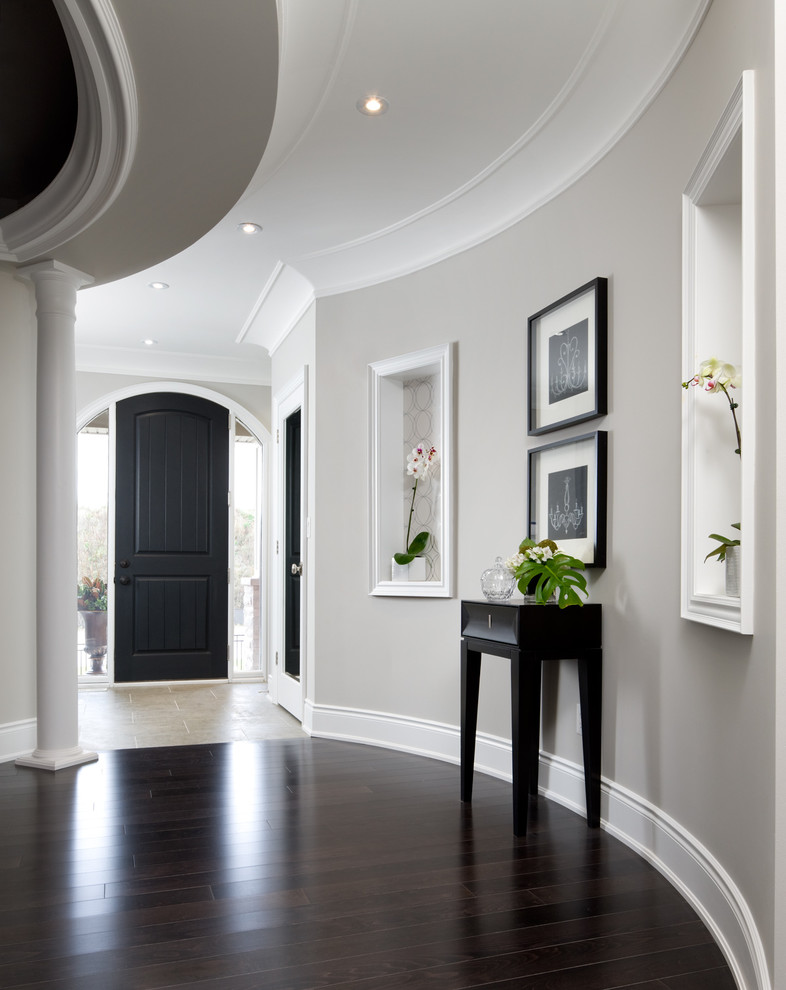 Transitional brown floor hallway photo in Toronto with gray walls