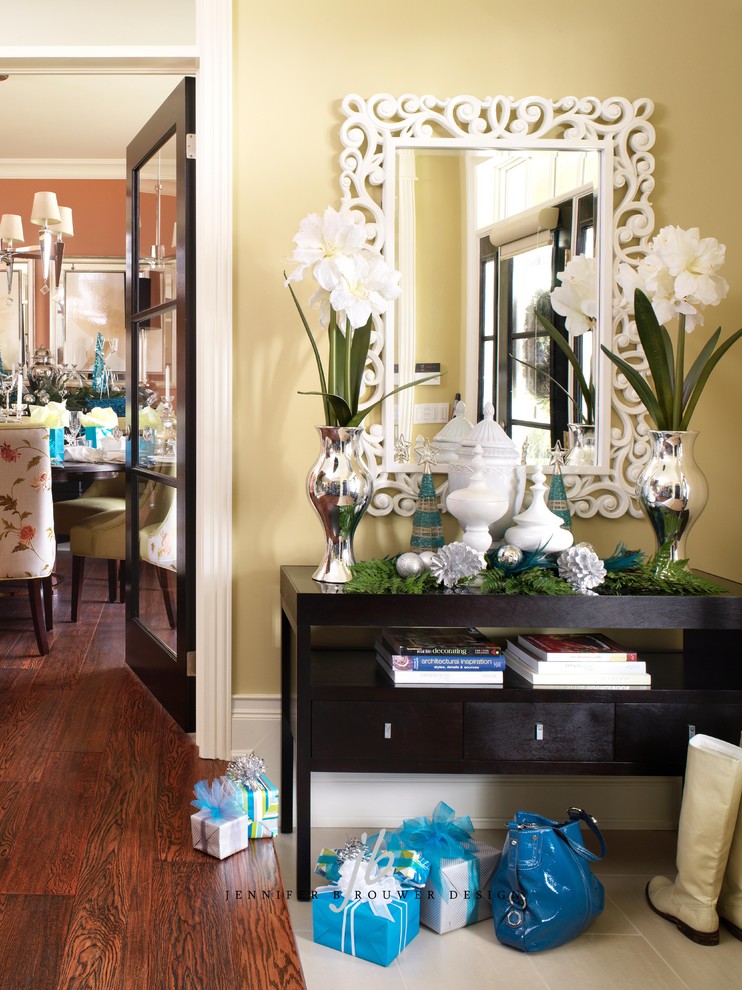Inspiration for a mid-sized transitional dark wood floor hallway remodel in Toronto with yellow walls