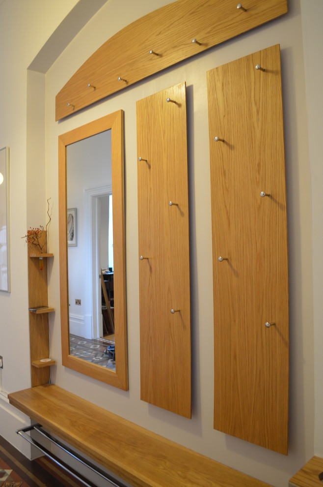 Example of a small minimalist hallway design in Cardiff with white walls