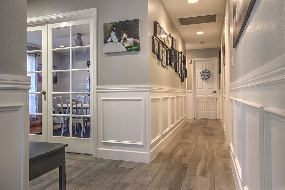 Example of a large transitional porcelain tile hallway design in Phoenix with gray walls