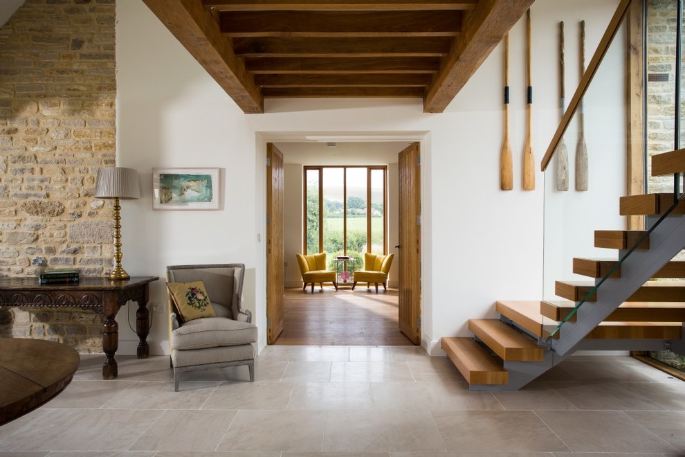 Example of a country gray floor hallway design in Dorset with white walls