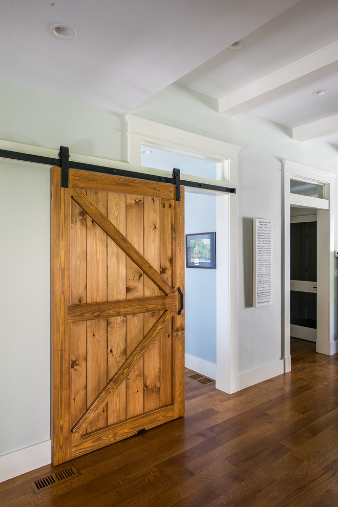 Inspiration for a mid-sized country medium tone wood floor and brown floor hallway remodel in Boston with green walls