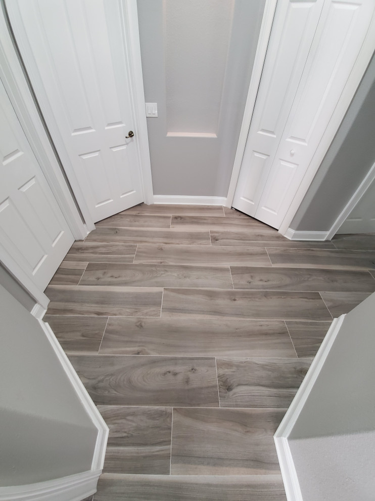 Mid-sized minimalist porcelain tile and gray floor hallway photo in Orlando with gray walls