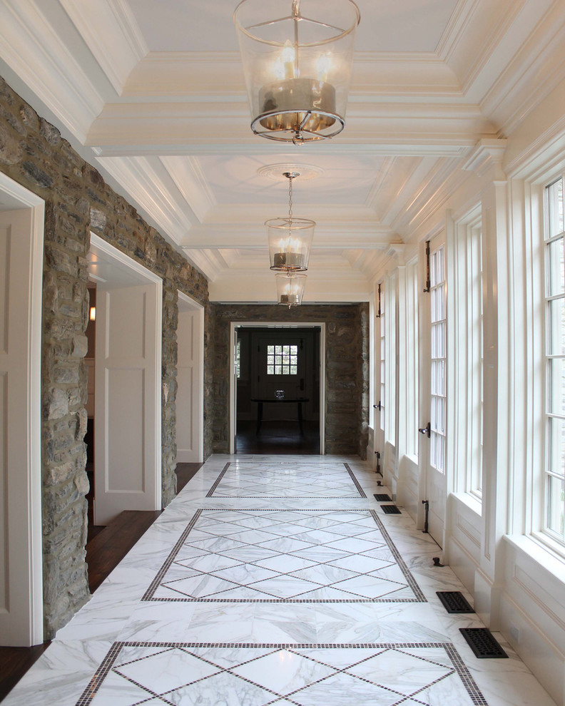 Example of a large classic marble floor and gray floor hallway design in Philadelphia with gray walls