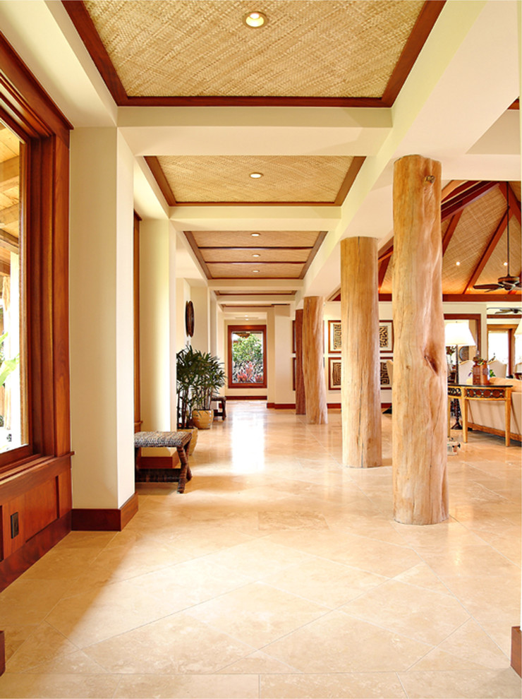 Large island style travertine floor and beige floor hallway photo in Hawaii with beige walls