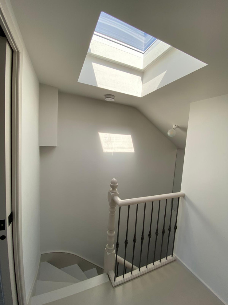 Example of a mid-sized classic painted wood floor and gray floor hallway design in London with gray walls