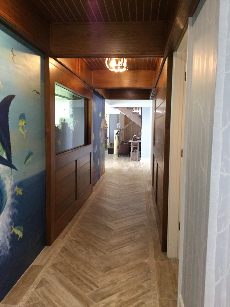 Example of a beach style porcelain tile and brown floor hallway design in Milwaukee