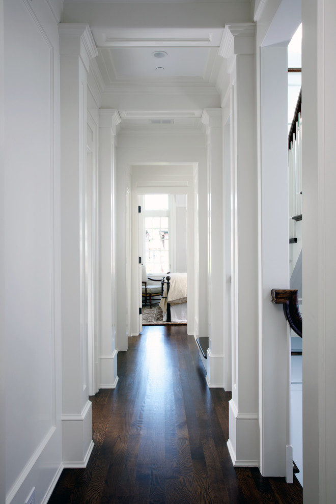 Example of a large classic dark wood floor hallway design in Chicago with white walls