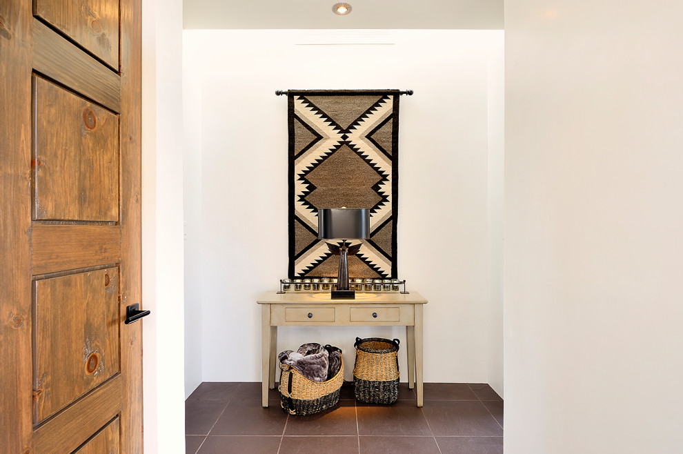 Inspiration for a mid-sized southwestern slate floor and brown floor hallway remodel in Albuquerque with white walls