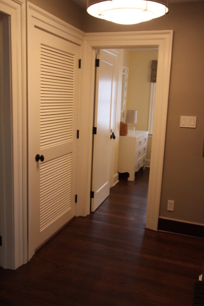 Mid-sized transitional dark wood floor hallway photo in New York with brown walls