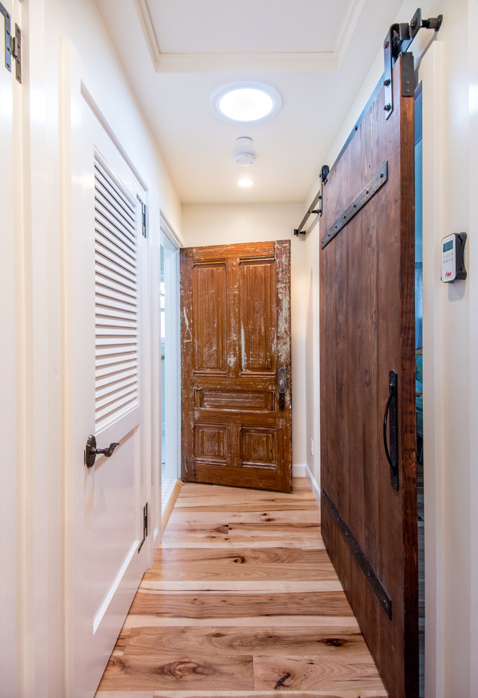 Inspiration for a small coastal medium tone wood floor hallway remodel in San Francisco with white walls