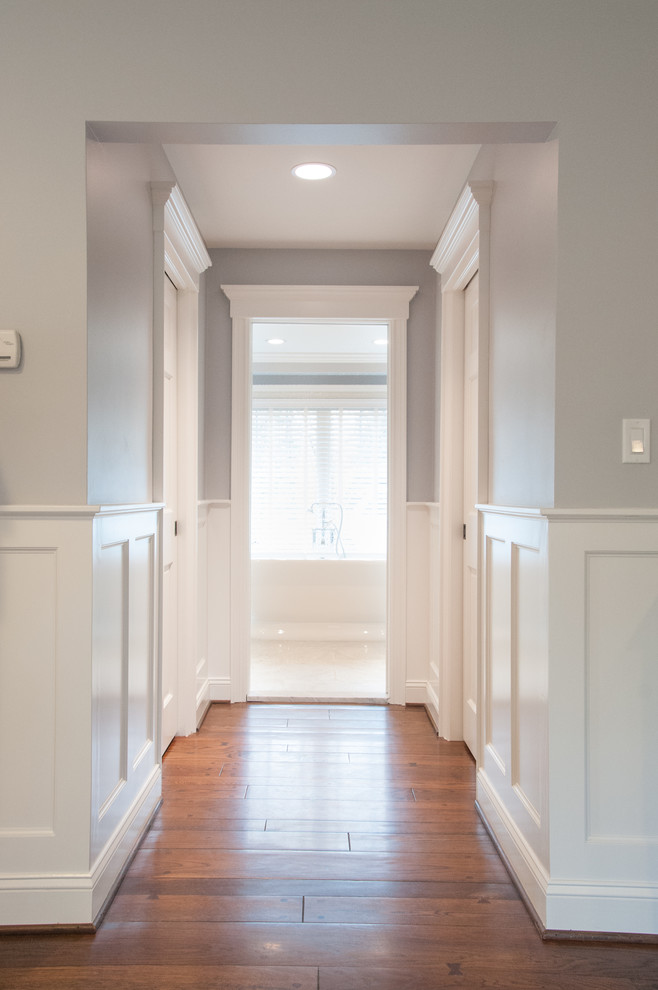 Foto di un ingresso o corridoio minimalista con pareti grigie e pavimento in legno massello medio