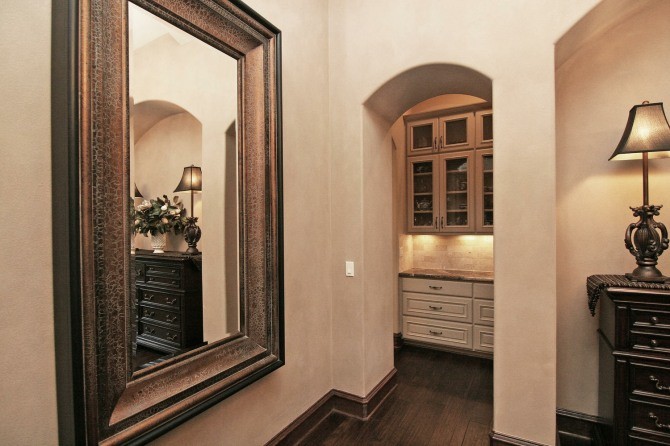 Inspiration for a mid-sized timeless dark wood floor and brown floor hallway remodel in Austin with beige walls