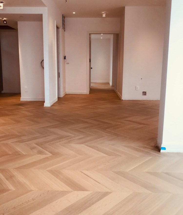 Large transitional light wood floor and beige floor hallway photo in Philadelphia with white walls
