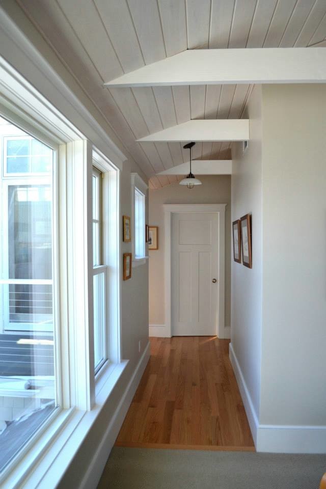 Immagine di un ingresso o corridoio costiero di medie dimensioni con pareti bianche, parquet chiaro e pavimento beige