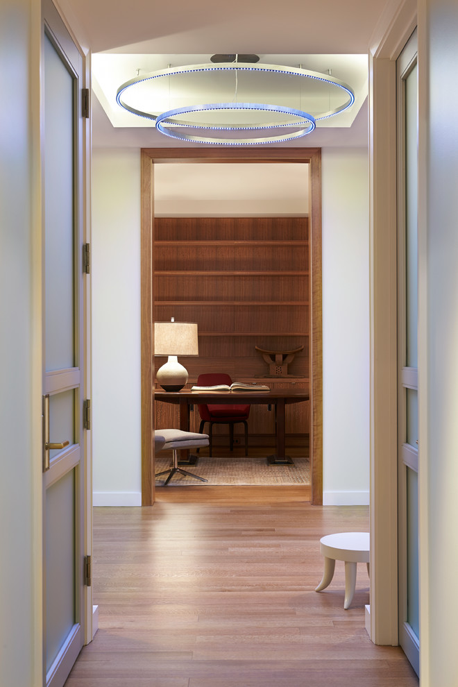 Inspiration for a contemporary medium tone wood floor hallway remodel in Detroit