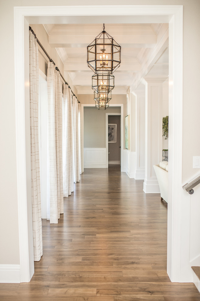 Hallway - large transitional dark wood floor and brown floor hallway idea in Orlando with beige walls