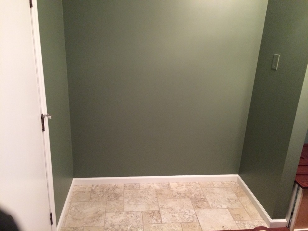 Cette photo montre un petit couloir chic avec un mur vert et un sol en carrelage de céramique.