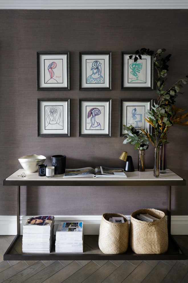 Inspiration for a mid-sized contemporary dark wood floor and brown floor hallway remodel in London with gray walls