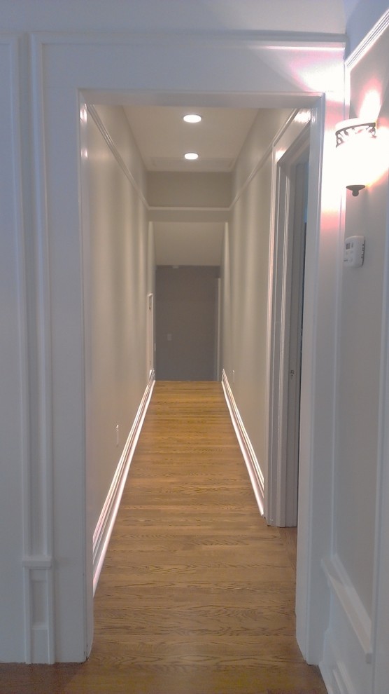 Inspiration for a large timeless medium tone wood floor hallway remodel in Newark
