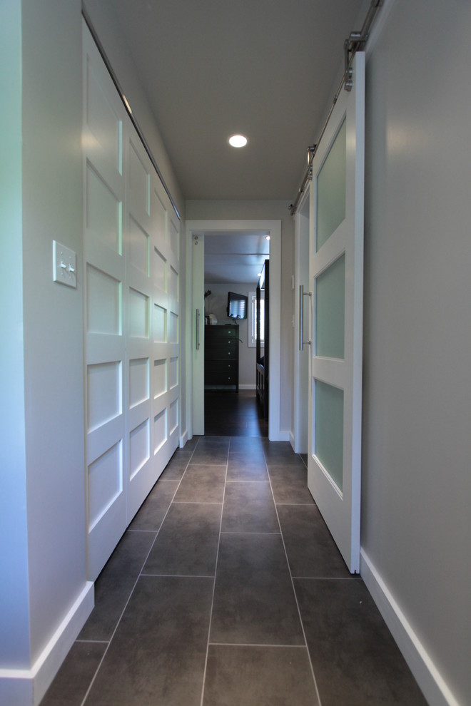 Mid-sized minimalist porcelain tile hallway photo in Seattle with gray walls