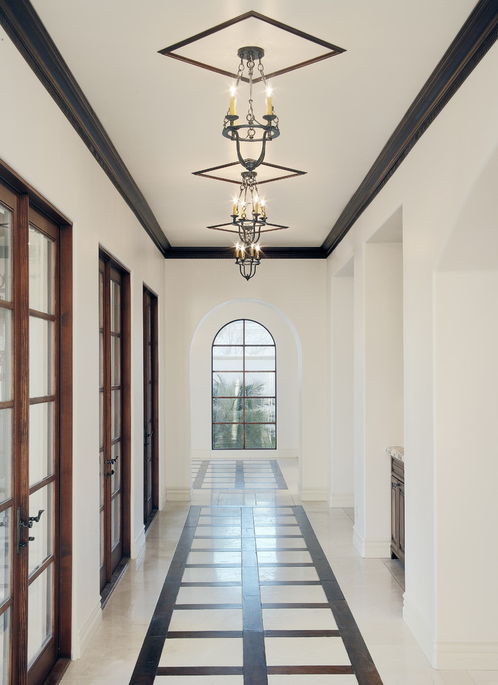 Hallway - mediterranean multicolored floor hallway idea in Phoenix with white walls