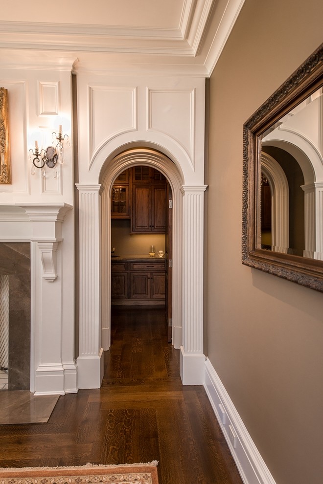 Hallway - small traditional dark wood floor hallway idea in New York with beige walls