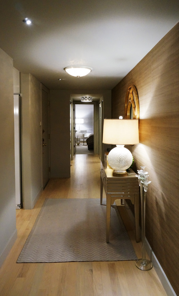 Hallway - large contemporary light wood floor hallway idea in Chicago with beige walls